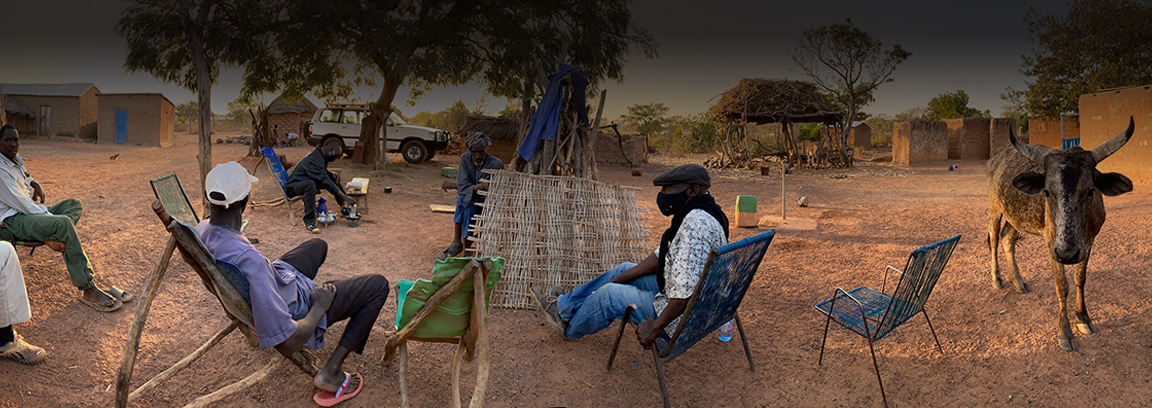 Men talking in West African village